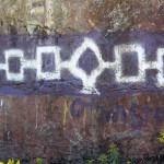 symbols representing the Hiawatha wampum belt painted in purple and white on a rock face