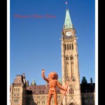 Toy figurine of Indian man in headdress and holding a shield and spear in foreground, Canada's Parliament Buildings and Clocktower in background